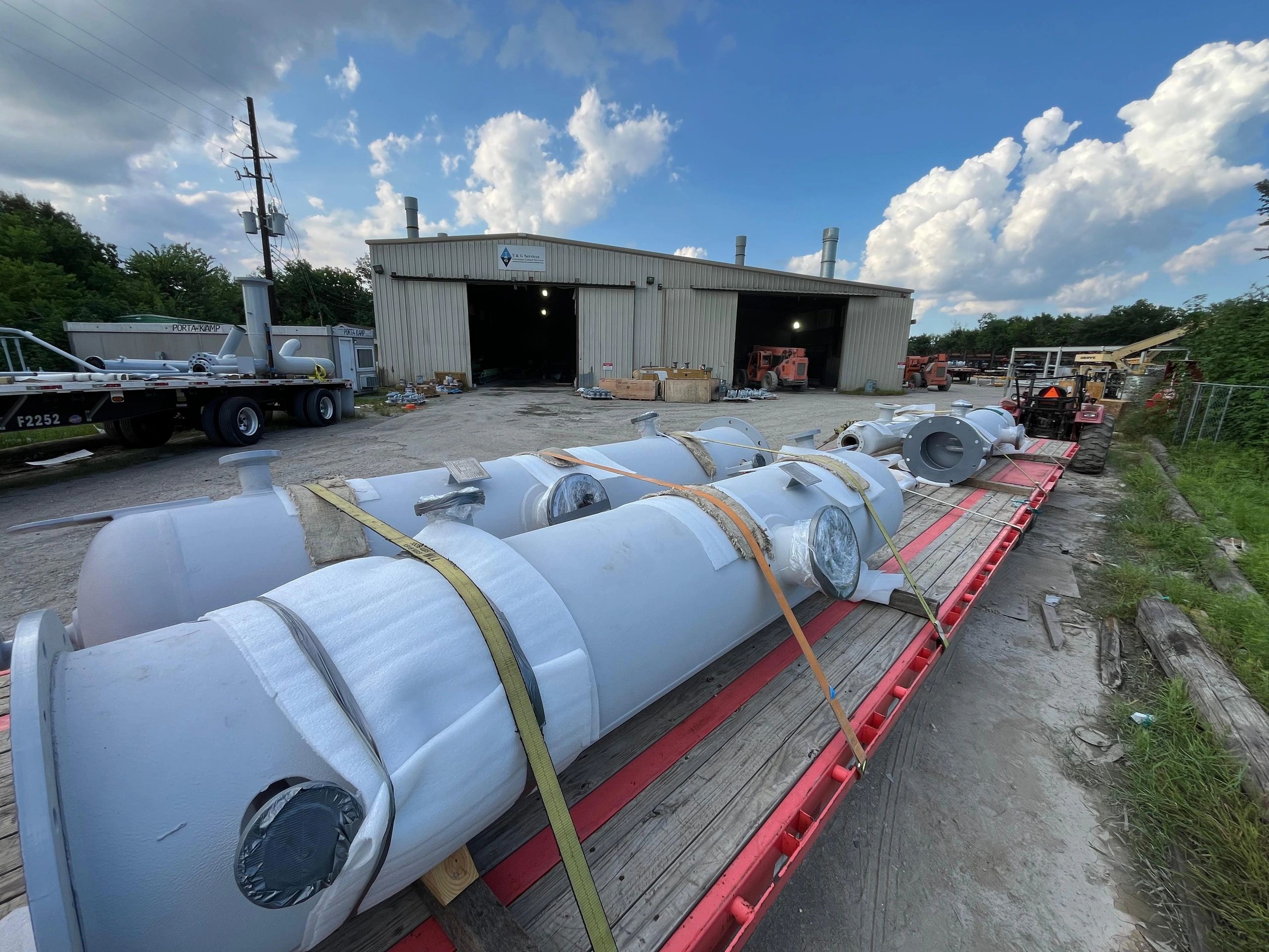 Industrial yard cylindrical tanks red trailers