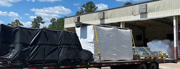 Flatbed truck loaded with cargo at warehouse