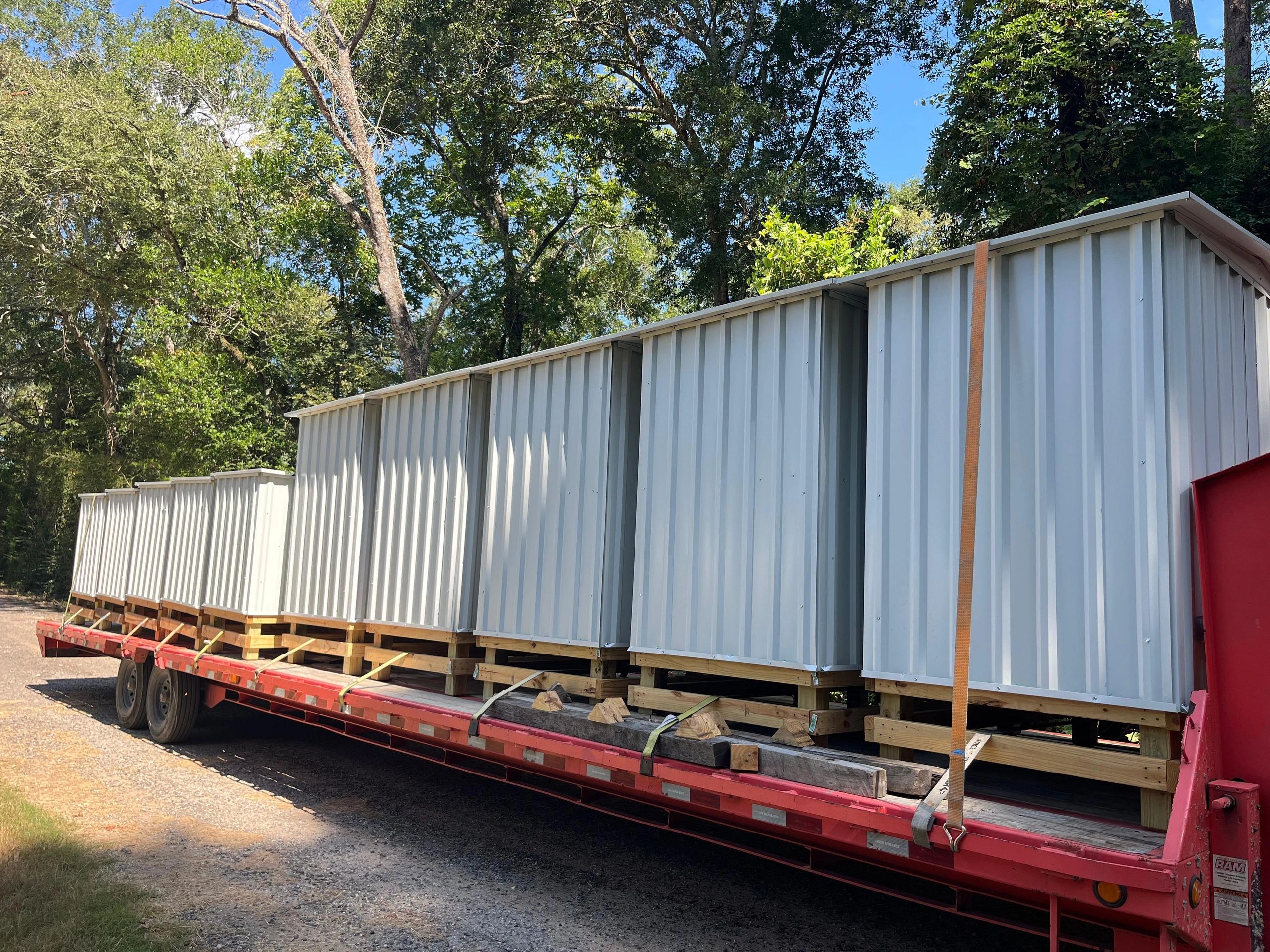 Modular building on flatbed trailer in woods