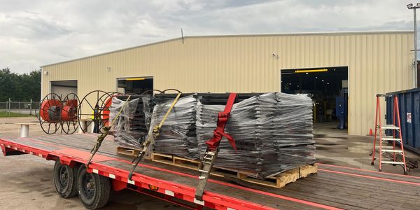 Red flatbed trailer at warehouse industrial yard
